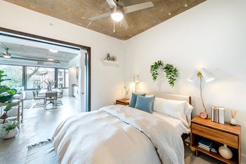 a bedroom with a bed and a ceiling fan